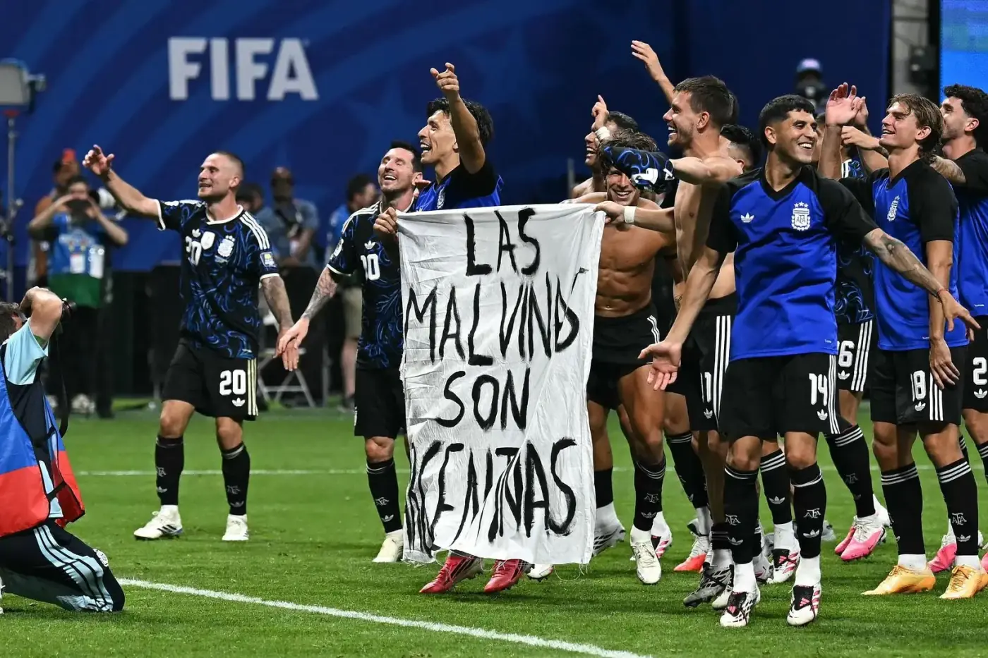 Argentina players display a Las Malvinas Son Argentinas banner on the pitch after the World Cup semi-final against England