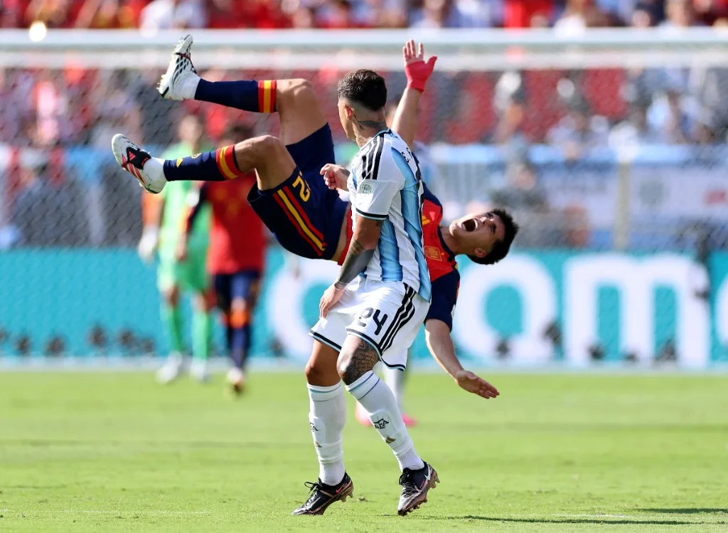 Enzo Fernández arrives late in a challenge on Spain defender Pau Cubarsí during the 2026 World Cup final