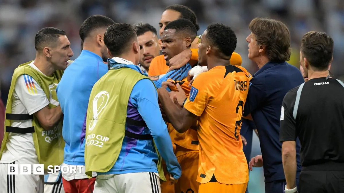 Players clash beside the Netherlands bench during the 2022 World Cup quarter-final